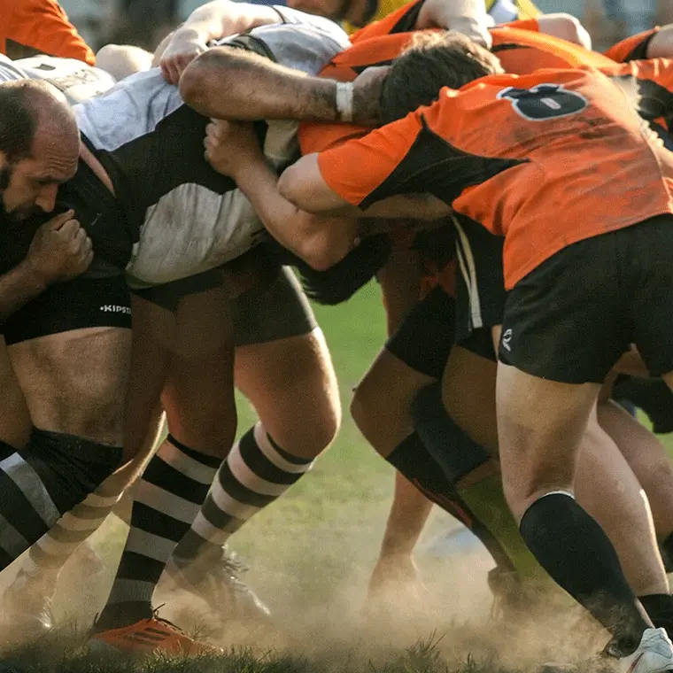 Rugby players from opposing teams locked in a scrum during an intense match