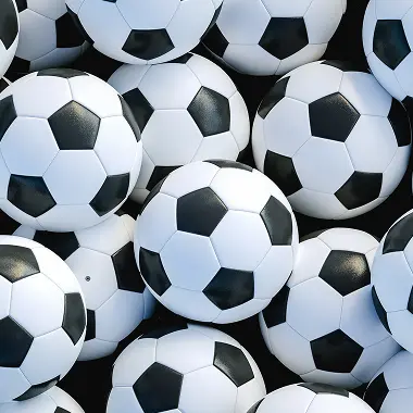 Pile of classic black and white soccer balls tightly packed together